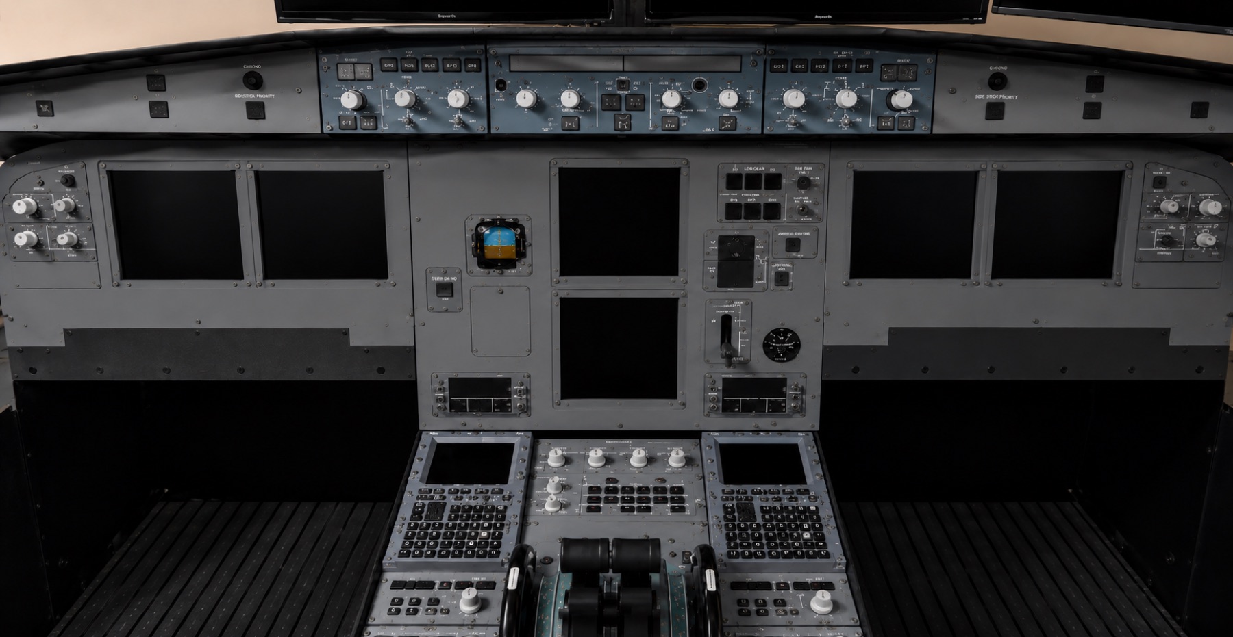 A320-style main instrument panel and center pedestal viewed in a bright room
